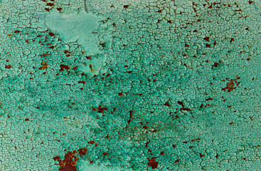 Green painted cracked peeling background with rust spots.