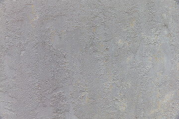 Light gray cracked painted background with rust stains.