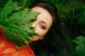 Beauty Of A Female Face With Healthy Skin And A Green Plant In Tropical Nature. Natural Organic Skin Care.