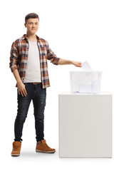 Young man putting a vote in an election box and looking at the camera
