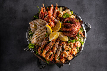 Mixed Seafood Contain Blue Crabs, Mussels, Big Shrimps, Calamari Squids and Grilled Barracuda Fish Garlic with Lemon on Dish