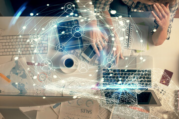 Double exposure of man and woman working together and social network theme hologram drawing. Computer background. connecting concept. Top View.