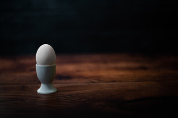 Egg in egg cup on a wooden table