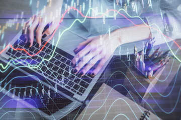 Double exposure of woman hands typing on computer and forex chart hologram drawing. Stock market invest concept.