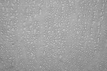 Gray background with raindrops. Tent inside in bad weather.