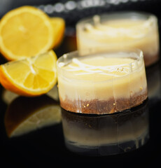Lemon cheesecake desserts on a reflective background