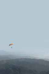 paragliding on blue sky in mountain landscape