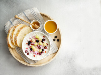 breakfast rice porrige  with honey and melon, berries