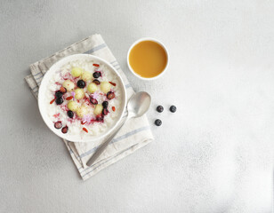 Fototapeta na wymiar breakfast rice porrige with honey and melon, berries