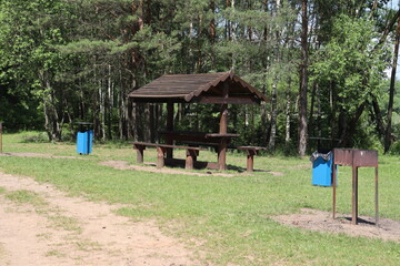 Fototapeta na wymiar picnic area with barbecue spot in forest