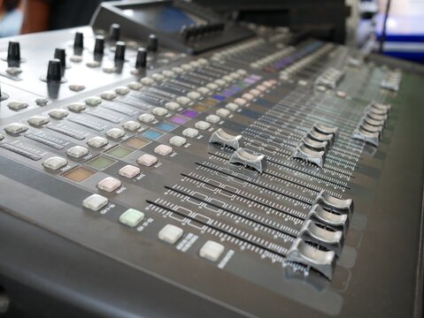 audio mixer equipment with buttons and sliders.