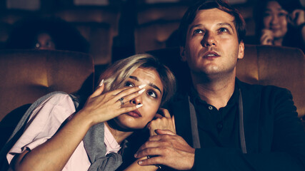 People audience watching movie in the movie theater cinema. Group recreation activity and...