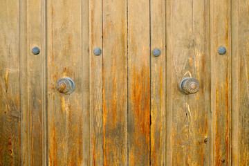 Very old church doors. Wooden panels and door knobs in a 19th century church, Europe..