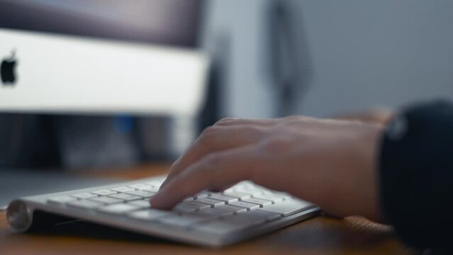 Hands typing on a keyboard