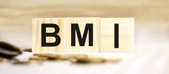 Acronym BMI - Body Mass Index. Wooden small cubes with letters isolated on black background with copy space available. Business Concept image.