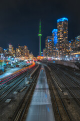 Fototapeta na wymiar Toronto Cityscape Skyline at Night with train and busy city skyscrapers