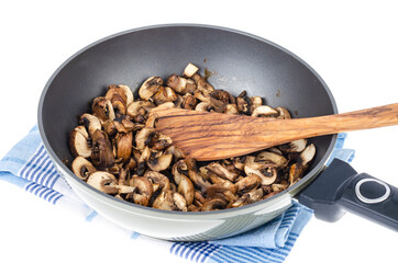 Sliced champignons fried in pan isolated on white background.