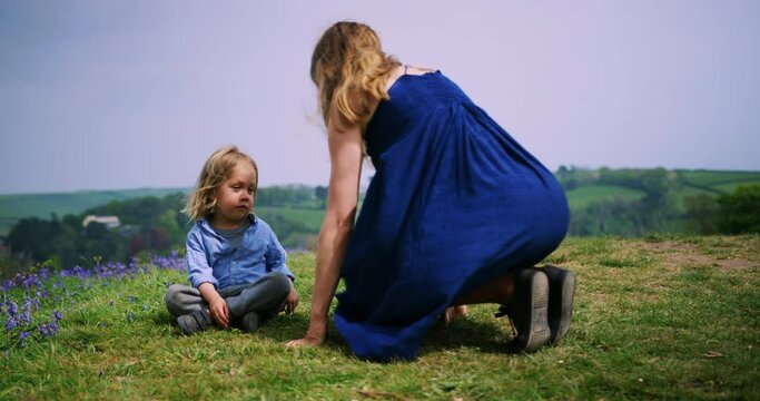 Young mother and preschooler relaxing in meadow