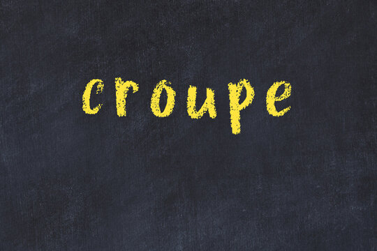 College chalk desk with the word croupe written on in