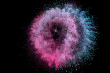 Splash of make-up brush rotation with color powder on black background.