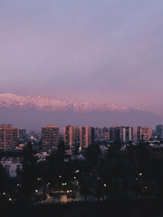 Amazing and beautiful purple tones sunset sky over Santiago downtown skyline and Los Andes mountains, Chile	