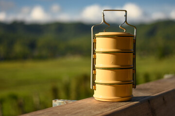 Tiffin box or food container on wooden table.blurred background.
