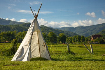 White tent in the sunset overlooking mountains and nature background.