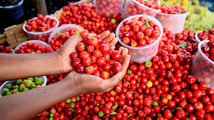 salvador, bahia / brazil - july 10, 2020: acerola fruit are seen for sale in the city of Salvador.
