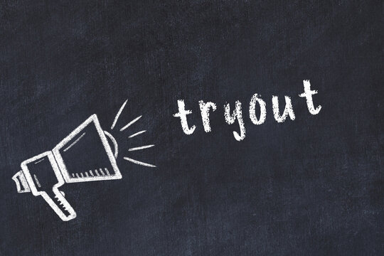 Chalk loudspeaker and inscription tryout on black chalkboard