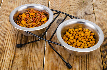 Granular pet food on brown wood background.