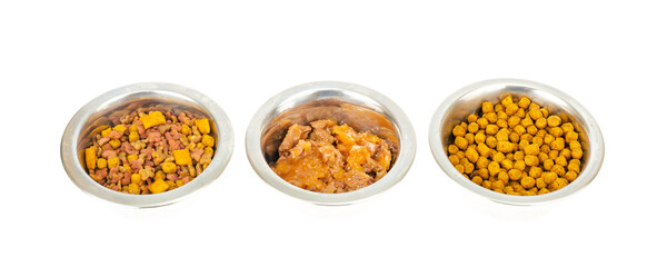 Metal bowls with different pet foods. Photo