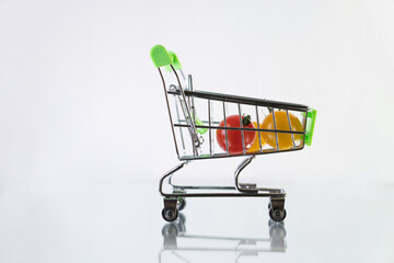 Buy tomatoes. Shopping at the supermarket. Grocery trolley. Food delivery.