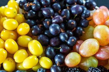 View from above. Mix of berries in a white terrel. Triangle separation. Summer mix of fruits. Stylish layout of berries