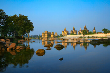 Naklejka premium View of Royal cenotaphs (Chhatris) of Orchha over Betwa river. Orchha, Madhya Pradesh, India.
