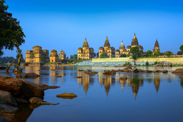 Fototapeta premium View of Royal cenotaphs (Chhatris) of Orchha over Betwa river. Orchha, Madhya Pradesh, India.