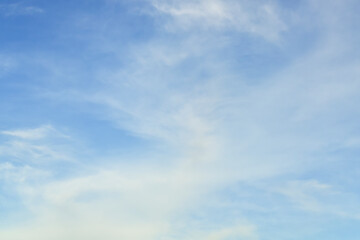 Thin white clouds on a blue sky background