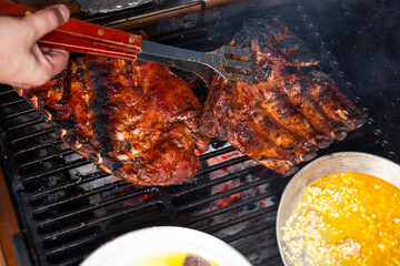 Grilled pork ribs, delicious grilled ribs, home barbecue - cooking grilled meat