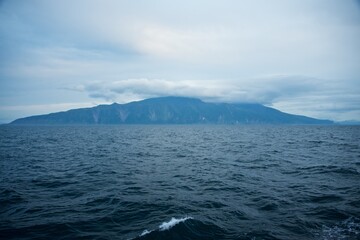 Steep shores of the Kuril Islands. Islands in the sea. Fall.