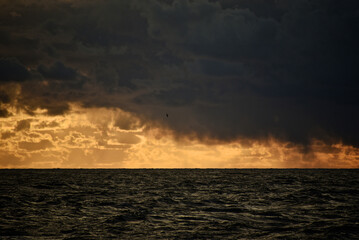 Epic cloud cover over the Pacific Ocean. Photo from the side of the ship. Autumn windy evening.