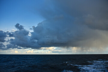 Fototapeta na wymiar Epic cloud cover over the Pacific Ocean. Photo from the side of the ship. Autumn windy evening.