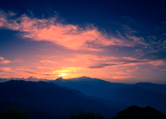 Fototapeta na wymiar Beautiful panoramic landscape sunrise view of the Himalayan snow mountains from Chandrashila peak in Chopta, Uttarakhand, India,.
