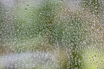 Naklejka na ściany i meble Close-up clear drops of water on window glass surface