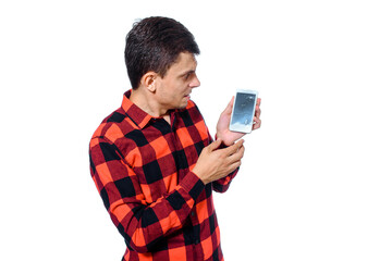 Man is holding his broken phone and shows it to the camera on white background.