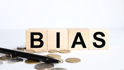 On a white background wooden cubes. Business concept. TEXT on Bias .Bias wooden blocks - word from...