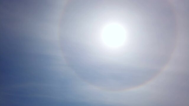 Atmospheric optical effect circle around the sun on hot summer day. Atmospheric halo phenomenon around the sun