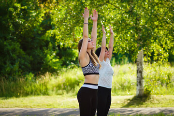 women in the Park with an instructor doing yoga