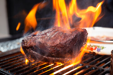 Grilled beef steak with flames, barbecue at home -delicious flaming picaña meat