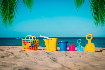 kid toys on tropical sand beach, family vacation