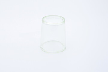 Transparent glass jars standing up against a white background.