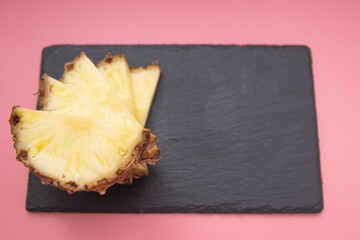pineapple slices on a stone slab. fresh fruit pineapple.